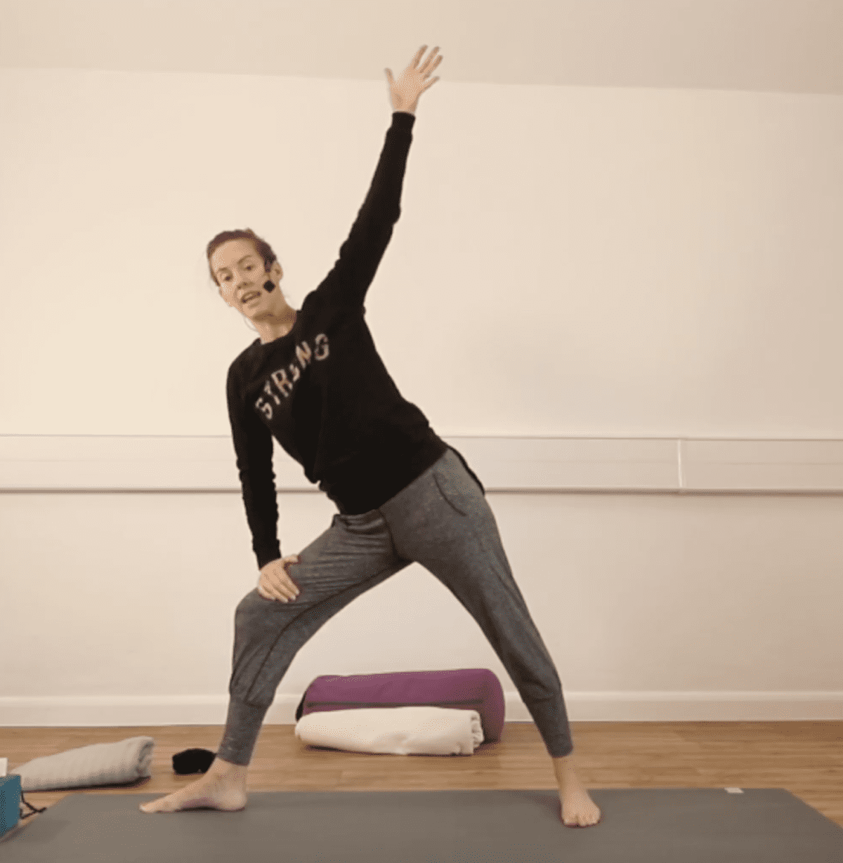 woman doing a standing side angle yoga posture
